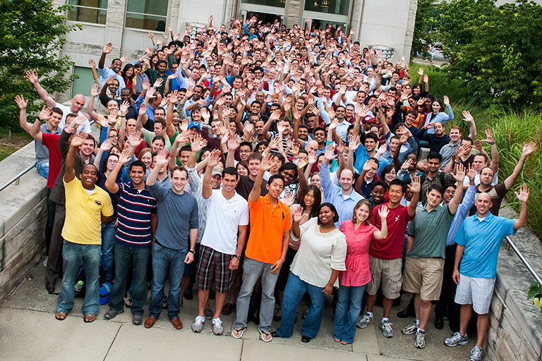 A large group of Kelley students waving at the camera