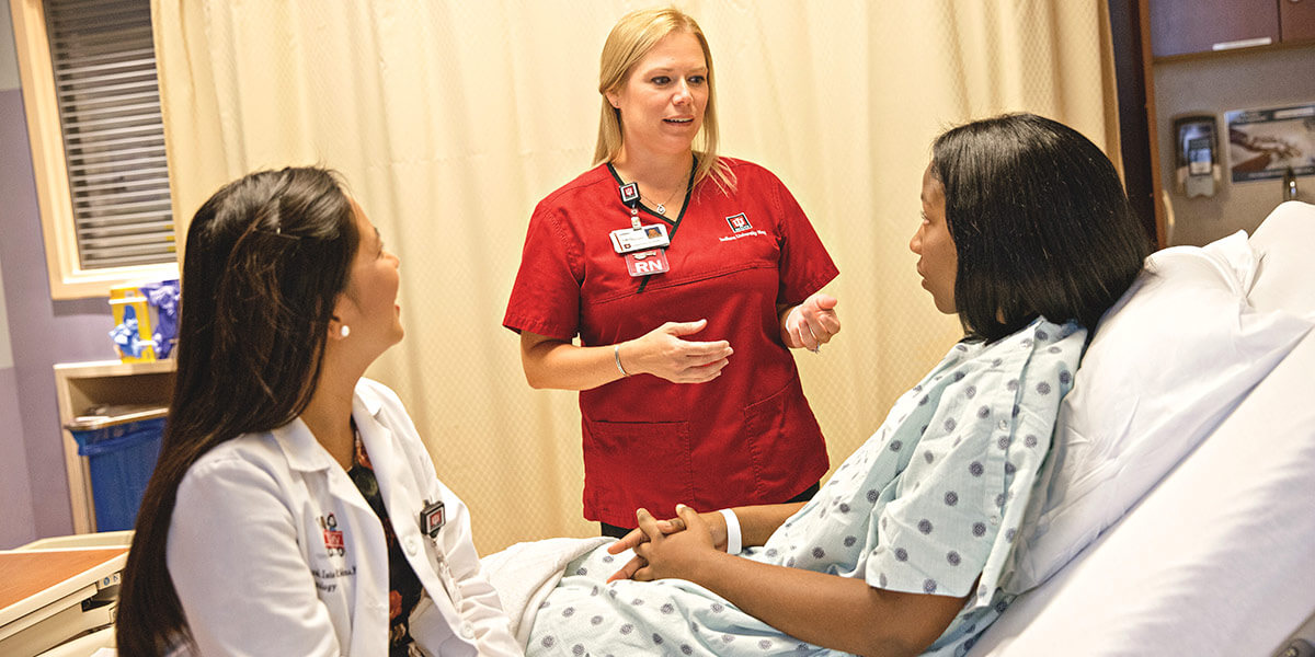 Healtcare staff speaking with a patient