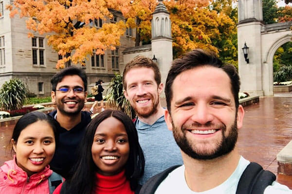 A group of four Kelley MBA students on a canoe trip. 