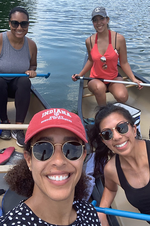 A group of four Kelley MBA students on a canoe trip. 