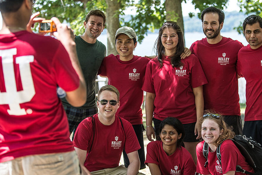 A group of Kelley Full-Time MBA students pose for a photo at an outdoor event. 