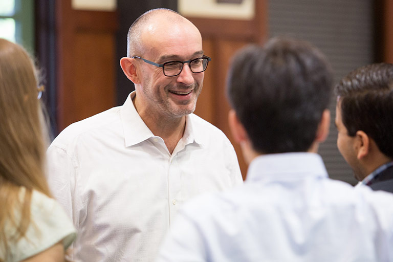 A Kelley MBA professor conversing with students