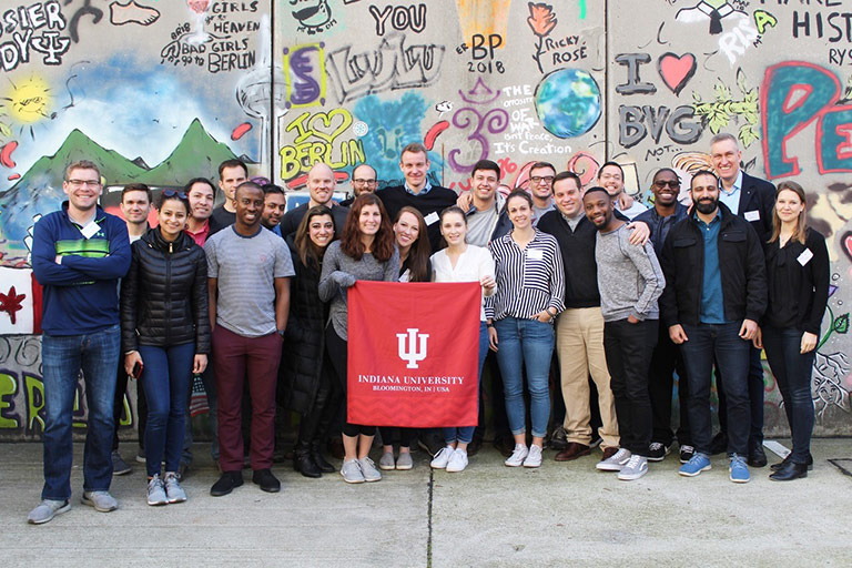 A group of Kelley students pose in front of a mural while studying abroad in Brazil