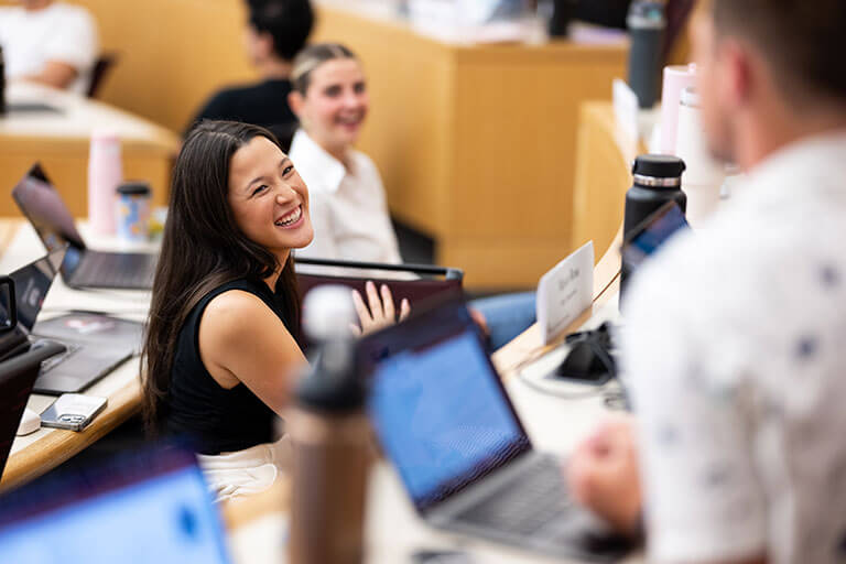 Kelley School of Business student laughing, smiling with students in classroom