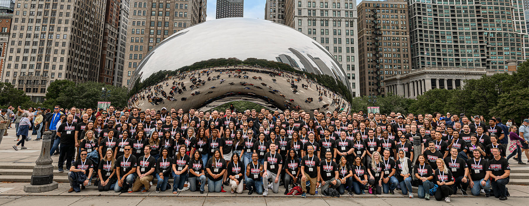 More than 100 Kelley Direct students pose in front of Cloud Gate or The Bean in Chicago's Millennium Park during a Kelley On Location event for online MBA students.