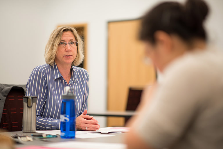 Kelley School of Business Professor Sonja Rego meets with a PhD student. 