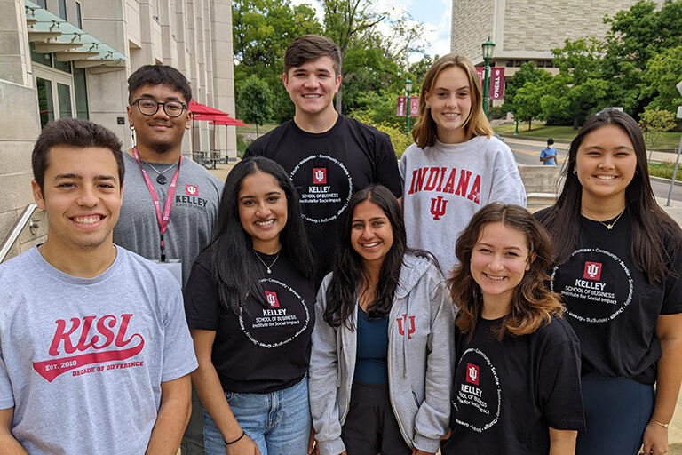 A diverse group of Kelley School of Business undergraduate student ambassadors pose together in the heart of IU's campus.